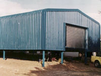 Enclosed structure with bullnose and roller shutter door – Chromadek.